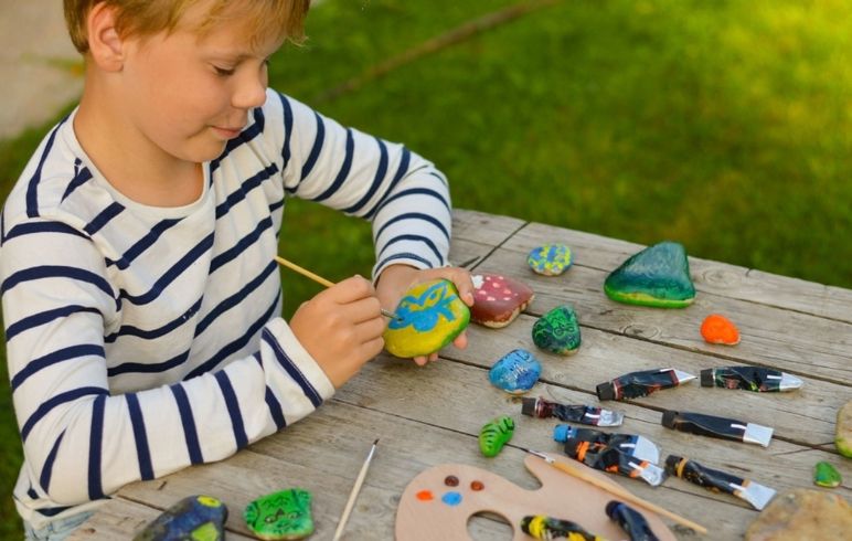 Kid doing Rock Painting