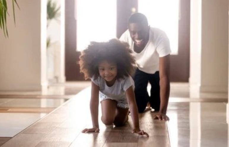 Father and daughter playing animal races game